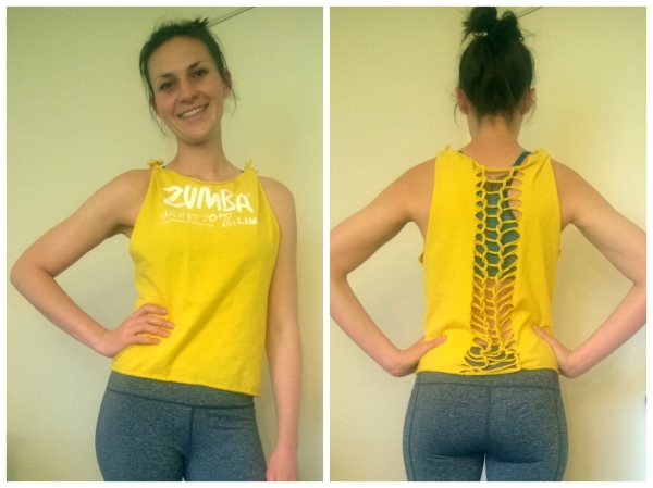 I got a free shirt from my Zumba instructor and decided to turn it into a tank.  Modifications: Cut the neck and arm pit holes.  Cut the bottom.  The shirt laid too far down my torso so I cut the tops of the straps and knotted them.  Did a very large braid on the back.